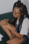 woman in white shirt holding green pen