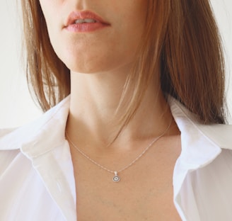 woman in white shirt wearing silver necklace
