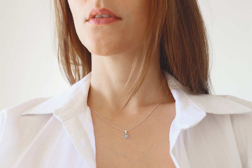 woman in white shirt wearing silver necklace