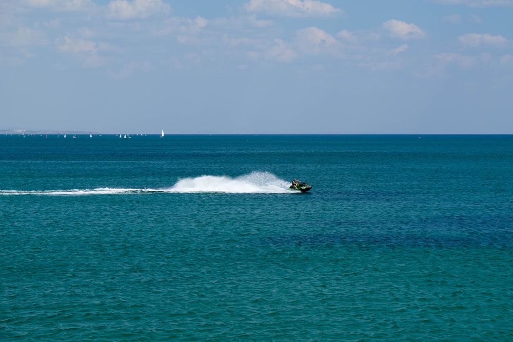 white and black boat on sea during daytime