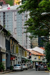 A vibrant street view with shops and apartments in Kuala Lumpur.