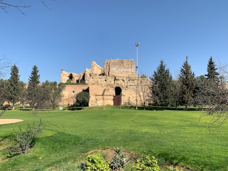 A serene view of the Cave of the Patriarchs surrounded by ancient stone architecture and lush greenery.