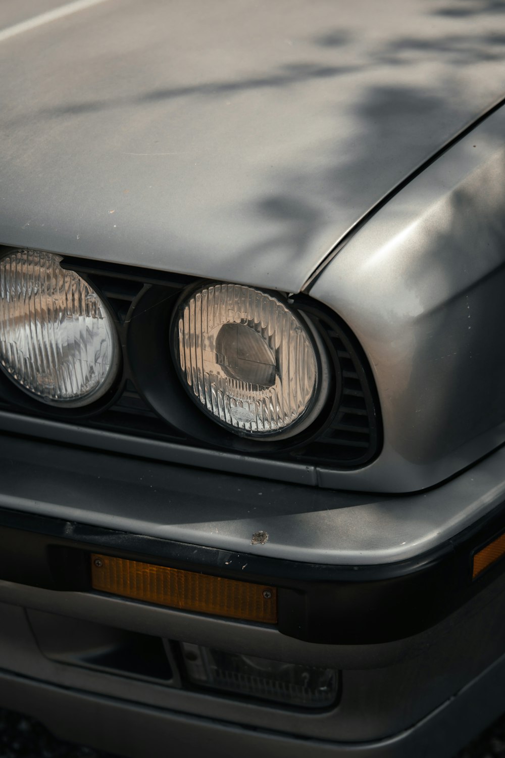 grey car with black and white round plate