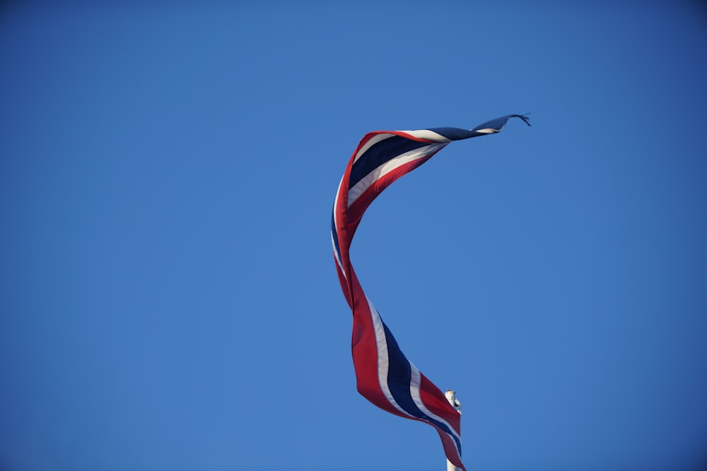 us a flag on pole under blue sky during daytime