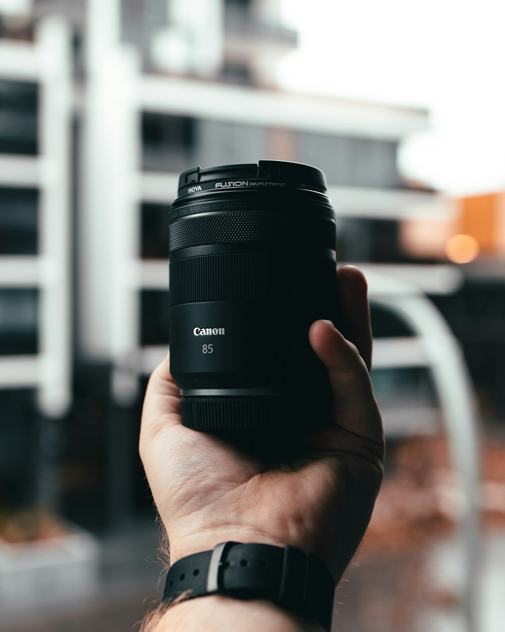 person holding black camera lens