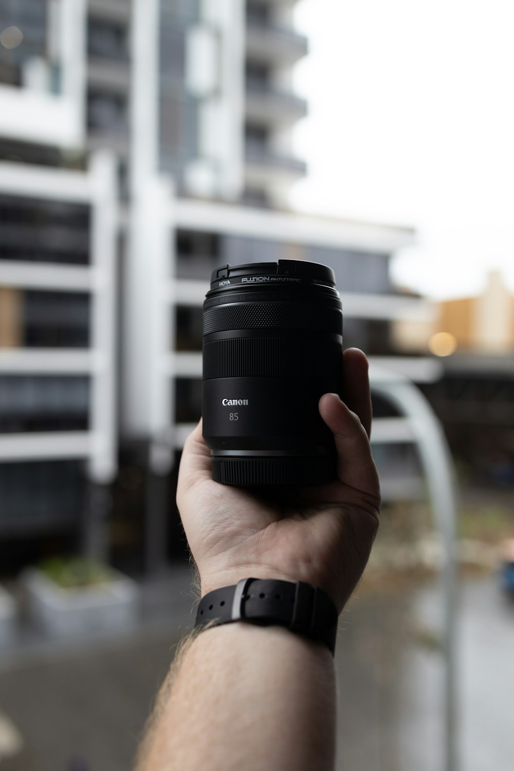 person holding black camera lens