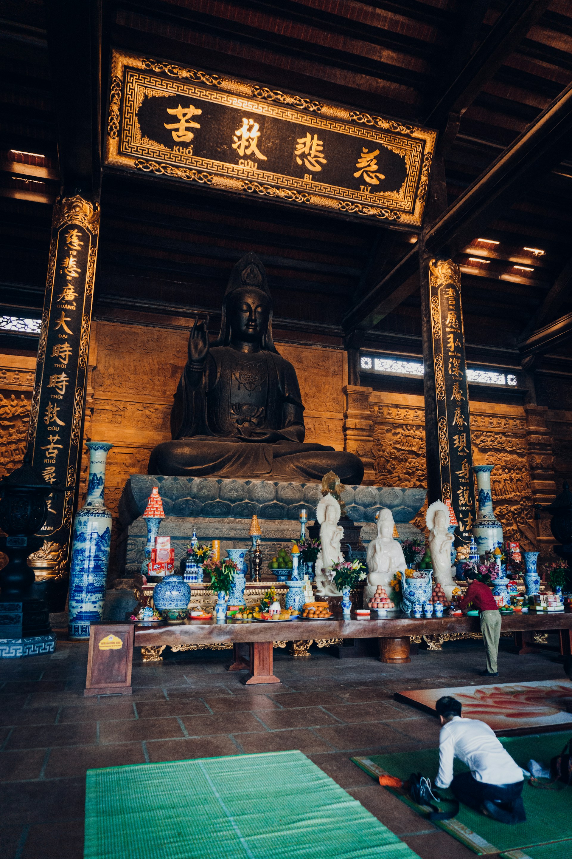 brown wooden buddha statue on brown wooden table
