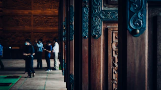 Team members carefully installing a large, elegant door, visible teamwork and attention to detail.