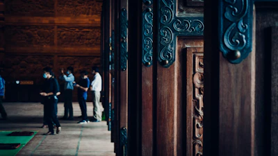Team members carefully installing a large, elegant door, visible teamwork and attention to detail.