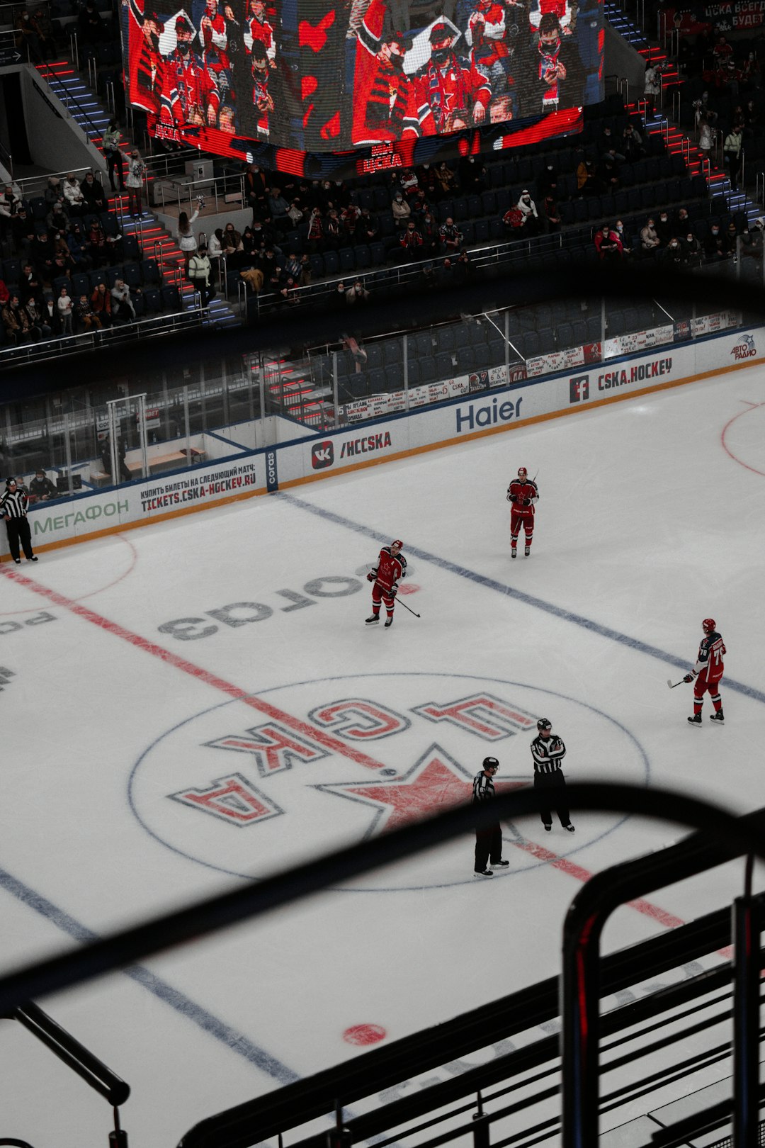 people playing ice hockey inside stadium