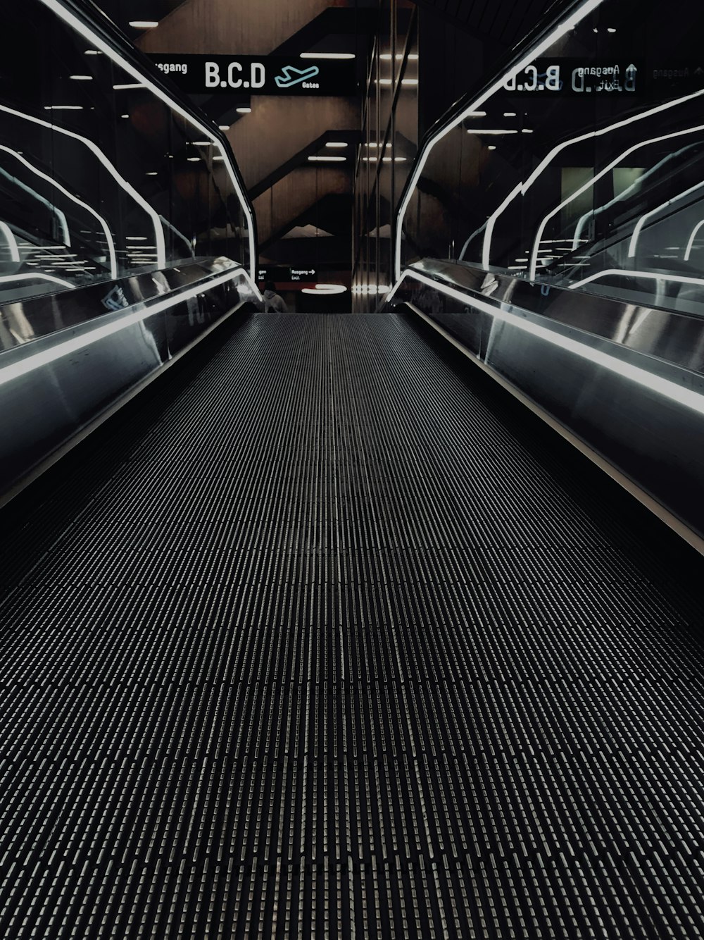 black and silver escalator in a train station