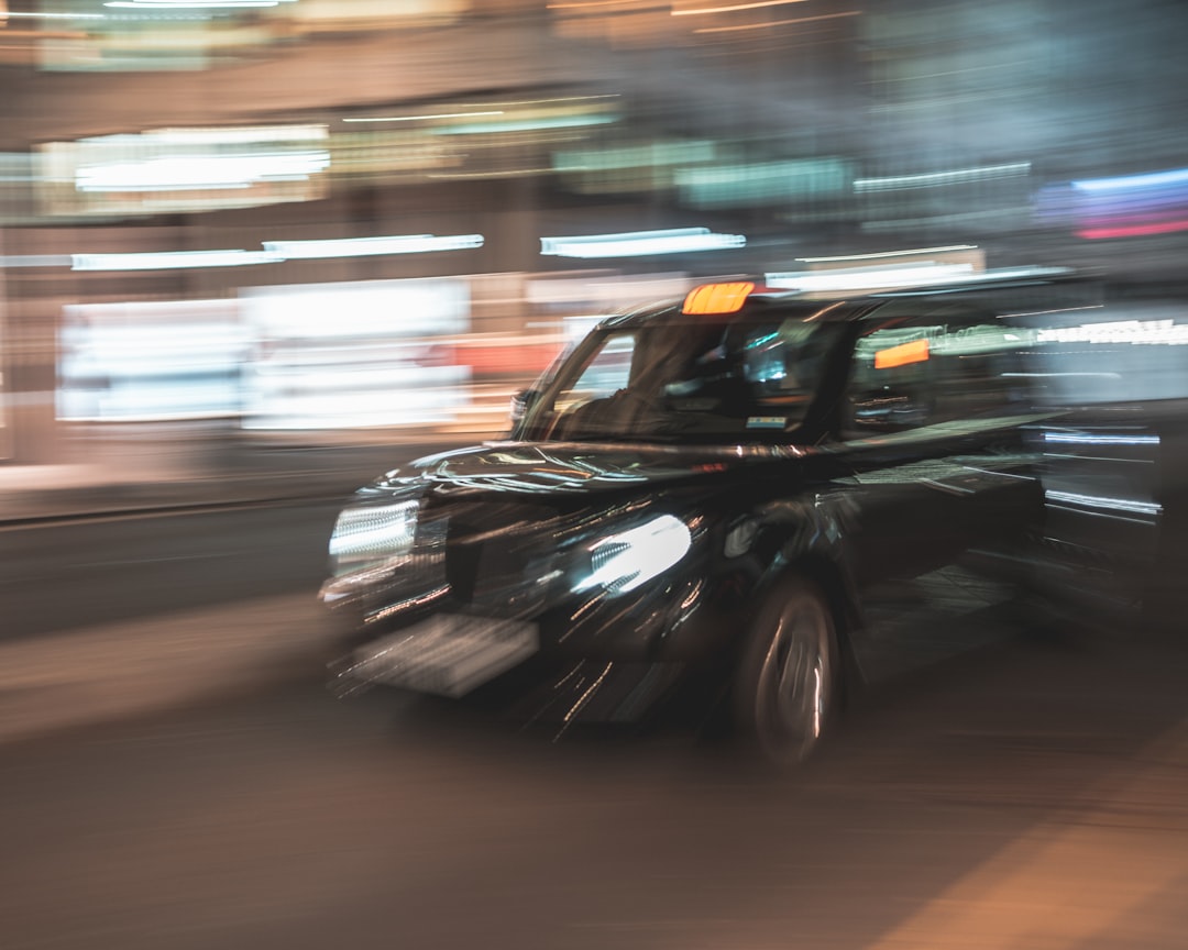 black car on road during night time