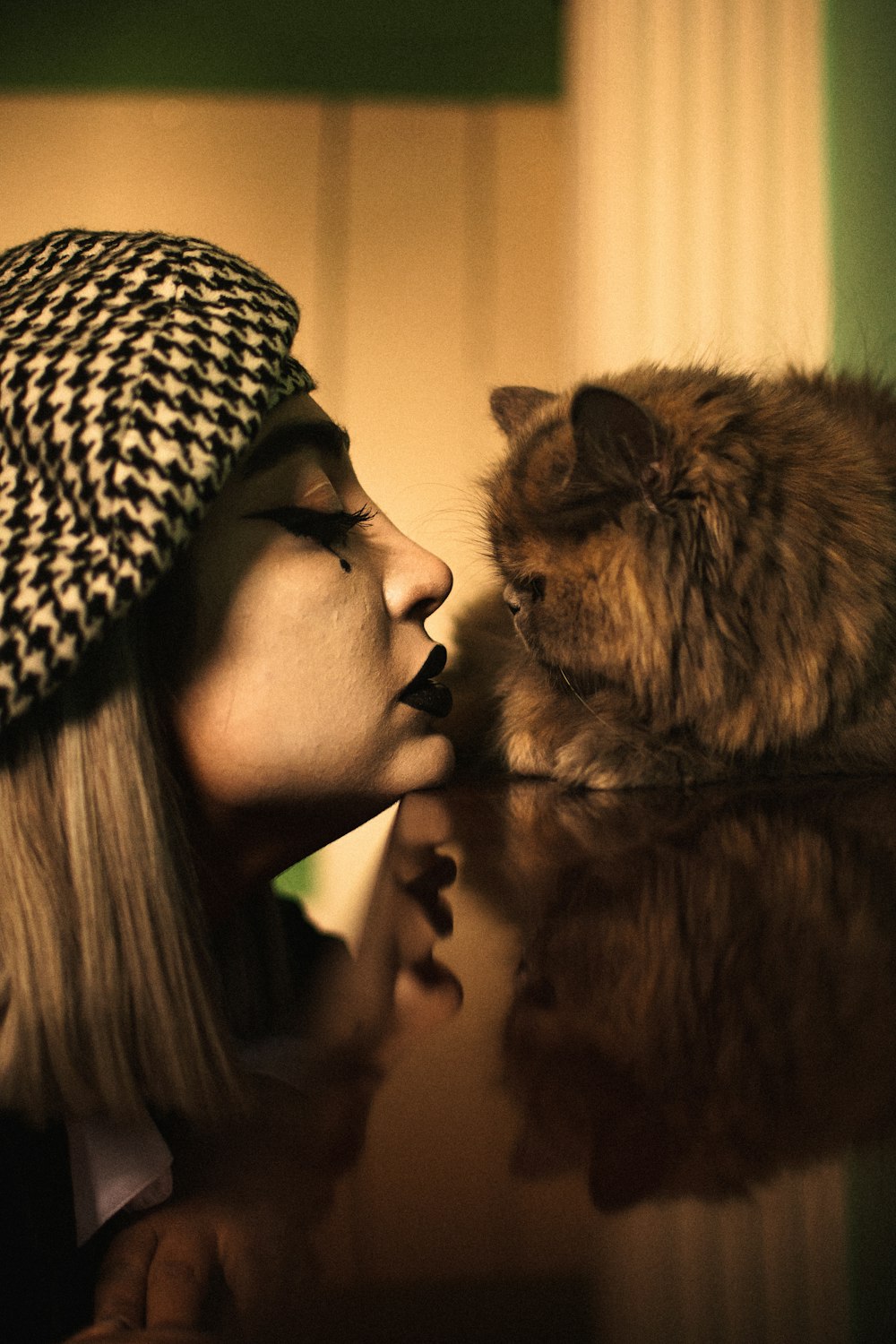 woman in black and white leopard print scarf with brown long fur cat