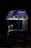 A person is sitting inside a small mobile ice cream cart with the Amul logo prominently displayed. The cart is primarily blue and purple with illuminated signs, and the person appears to be on a phone call. The setting seems to be dark, possibly at night, with the cart lit up against the surrounding darkness.