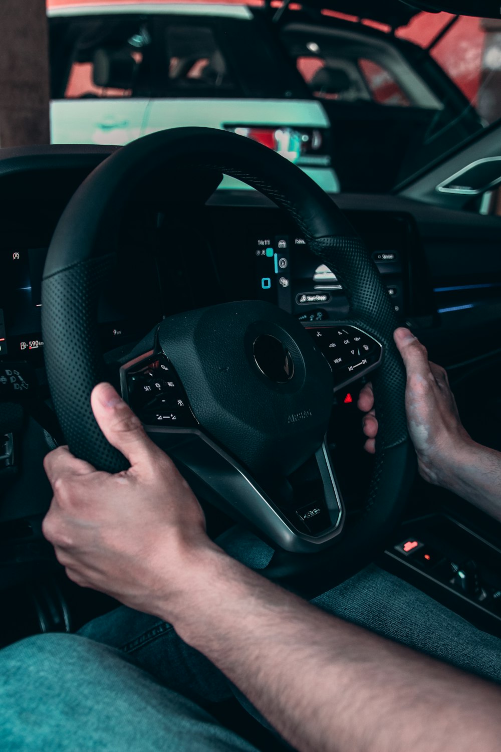 person holding black steering wheel