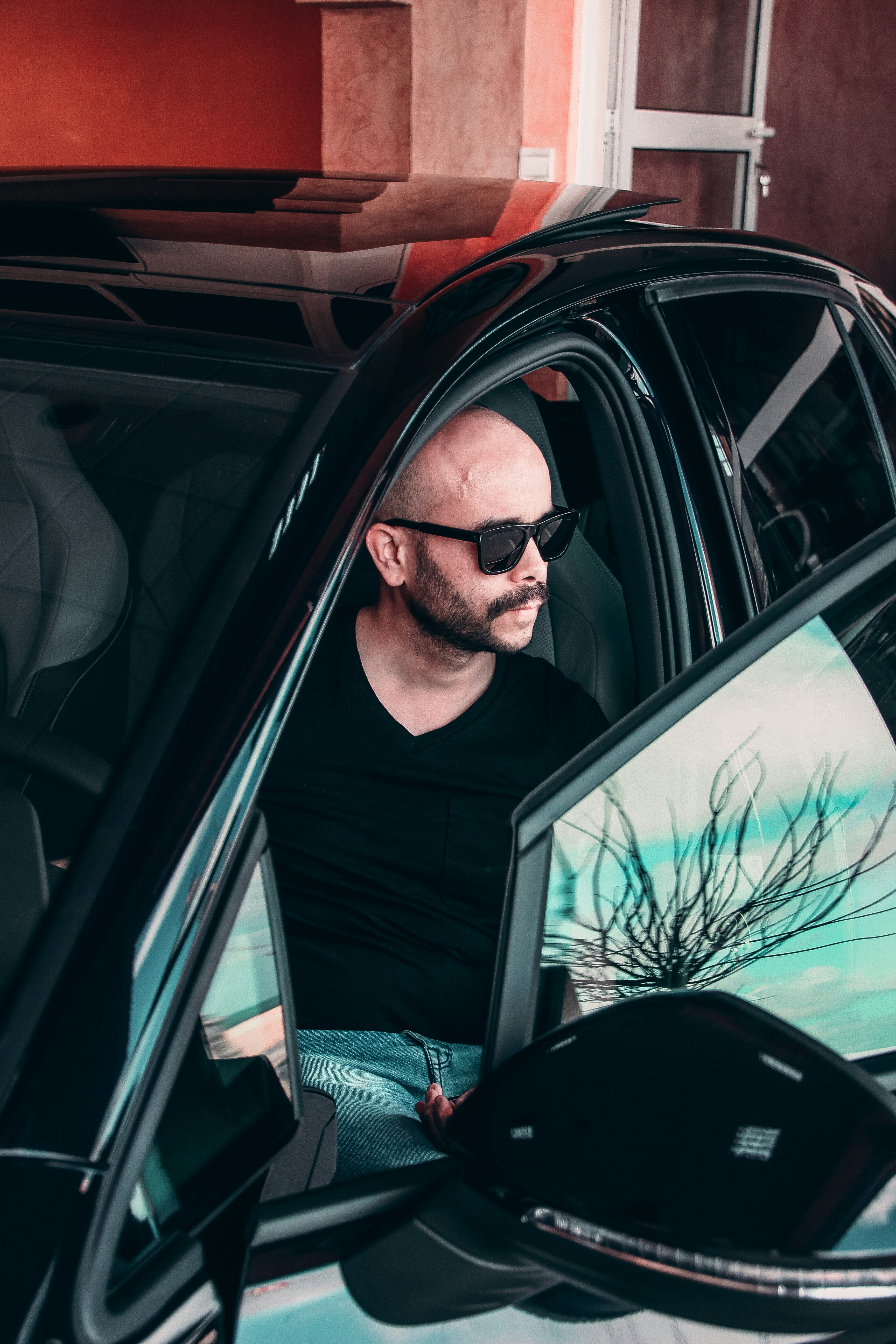 man in black crew neck shirt wearing black sunglasses