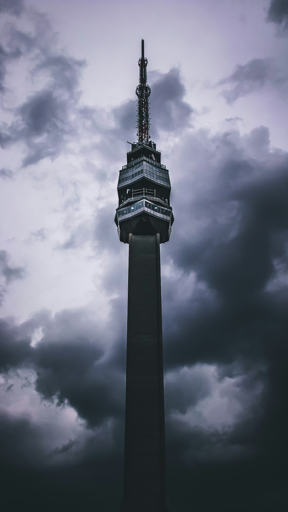 black and white tower under cloudy sky