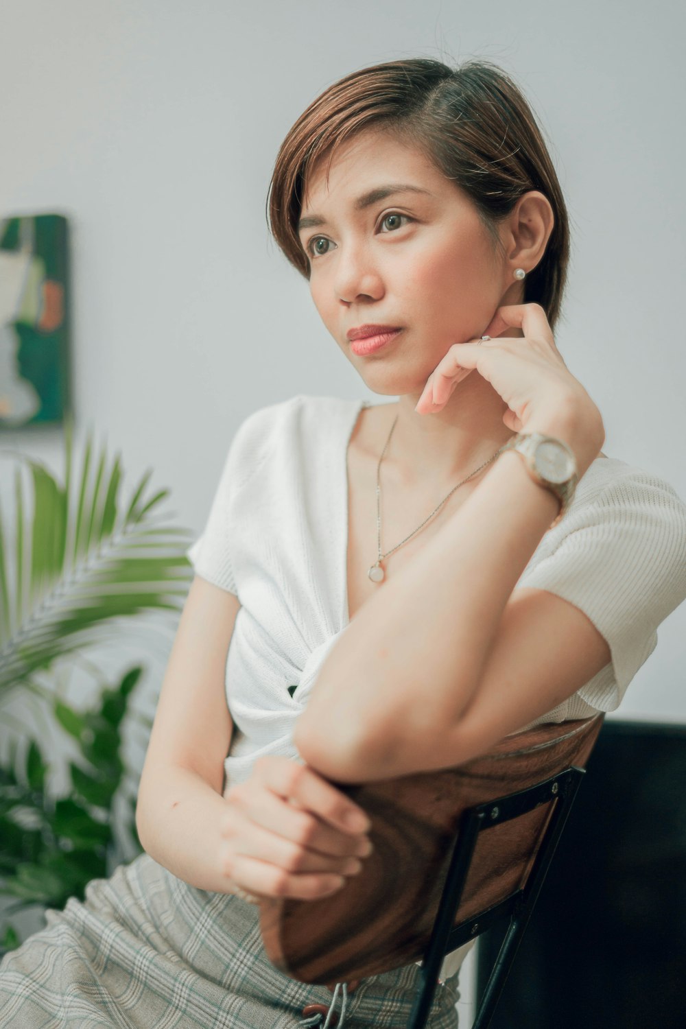 woman in white button up shirt sitting on chair