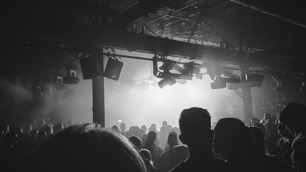 grayscale photo of people standing on stage