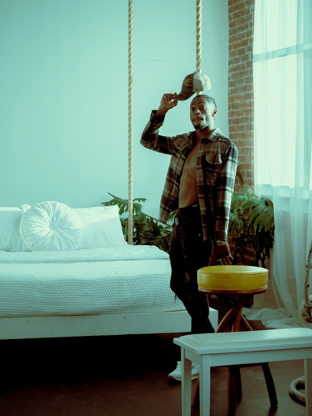 woman in brown and black plaid coat standing beside bed