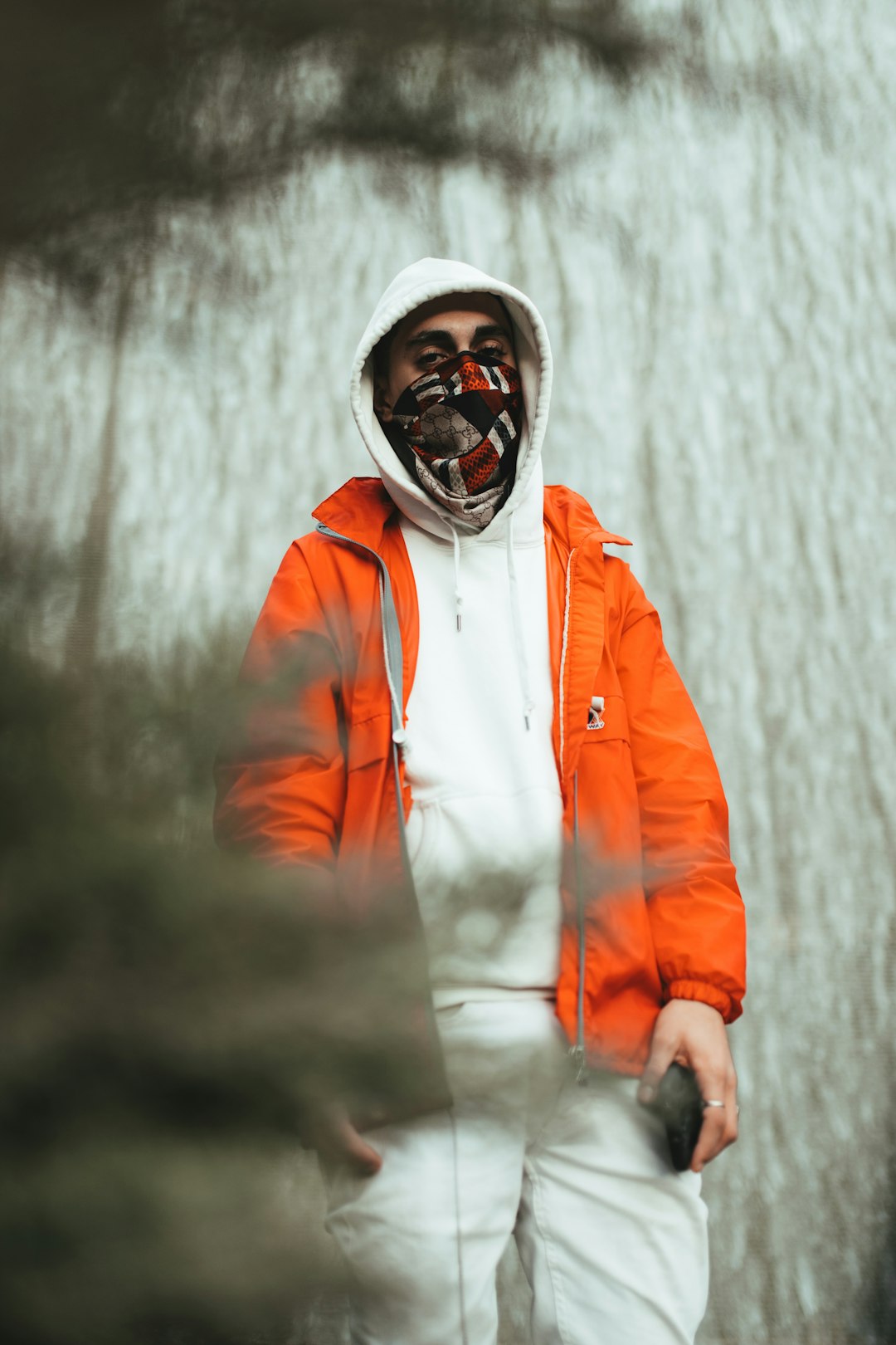 man in orange jacket wearing black goggles