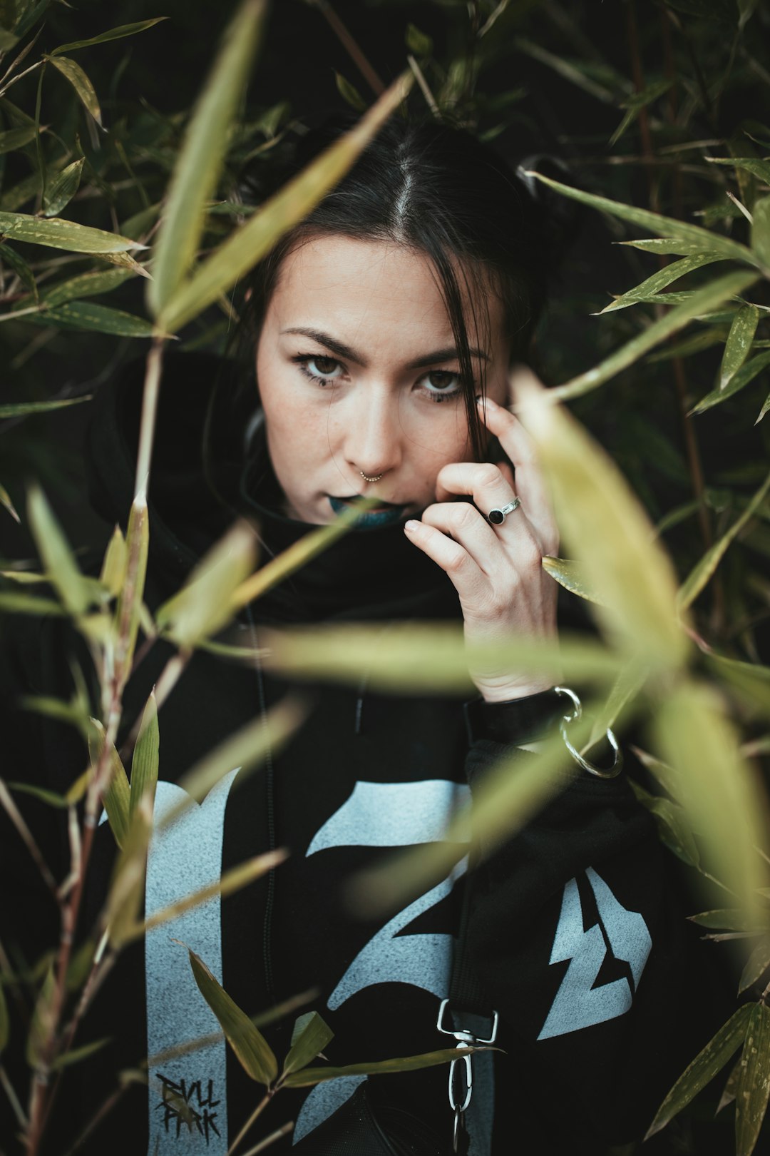 woman in blue and white stripe long sleeve shirt holding her face