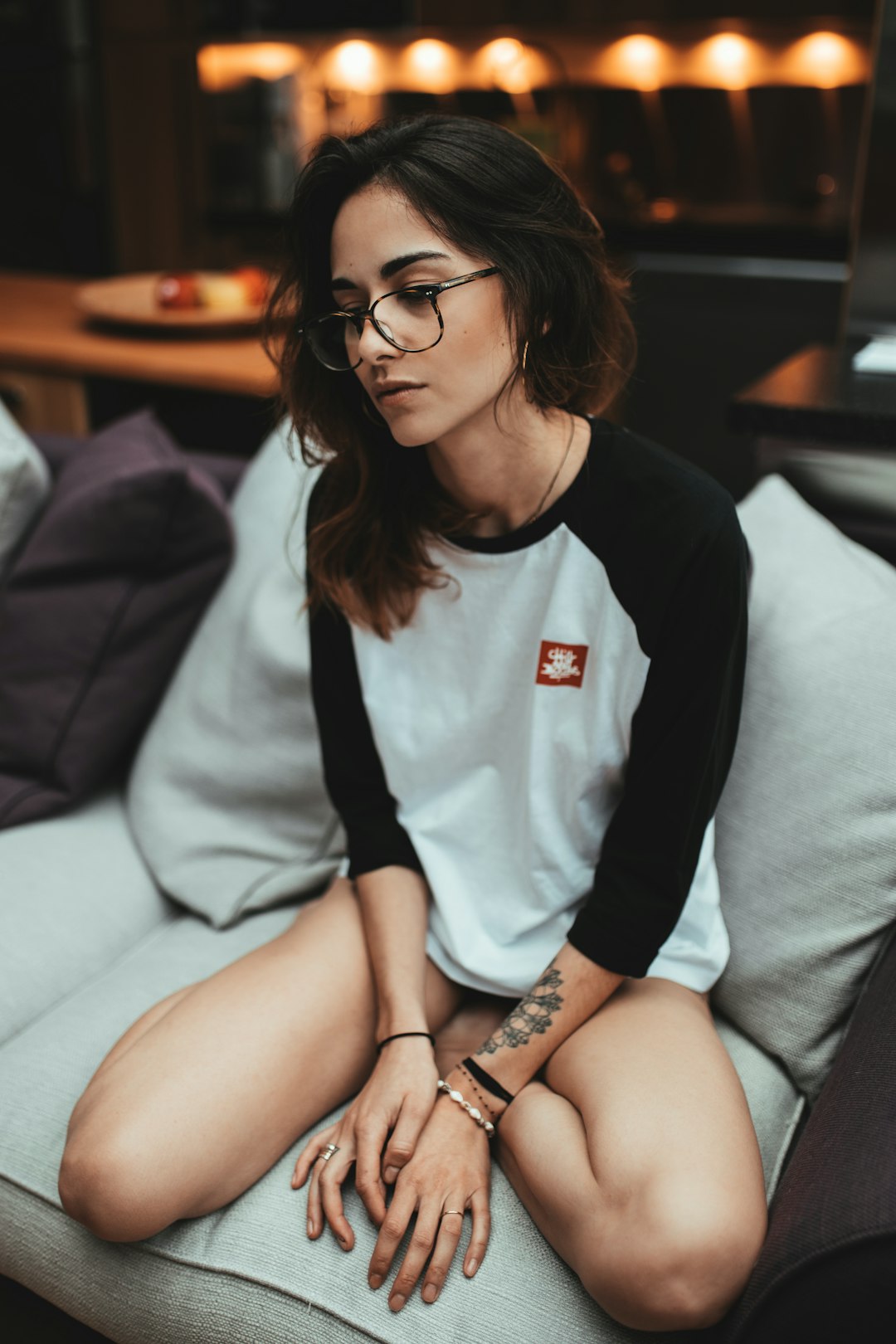 woman in white and black long sleeve shirt sitting on white couch