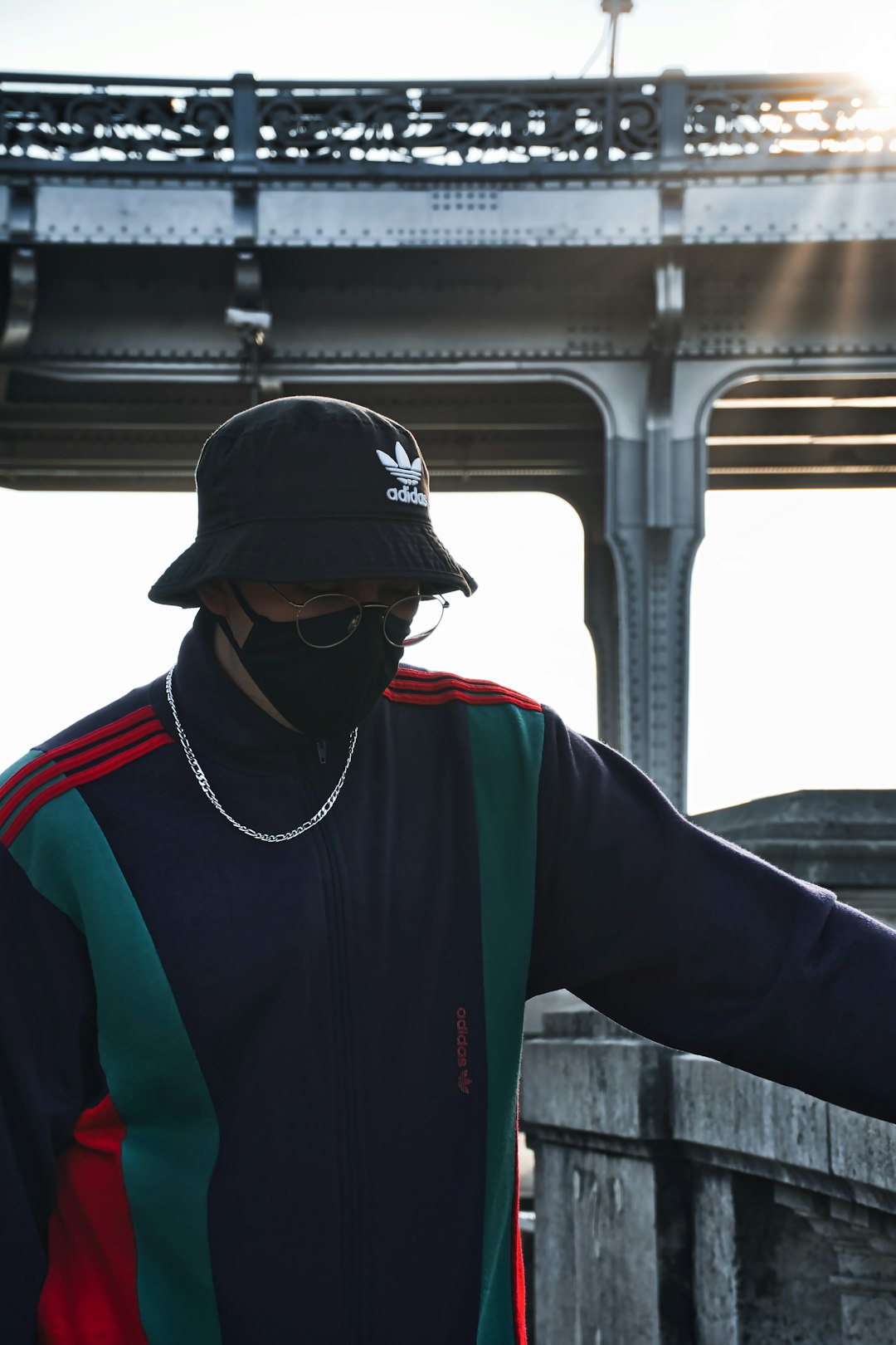 man in black and green jacket wearing black and red cap