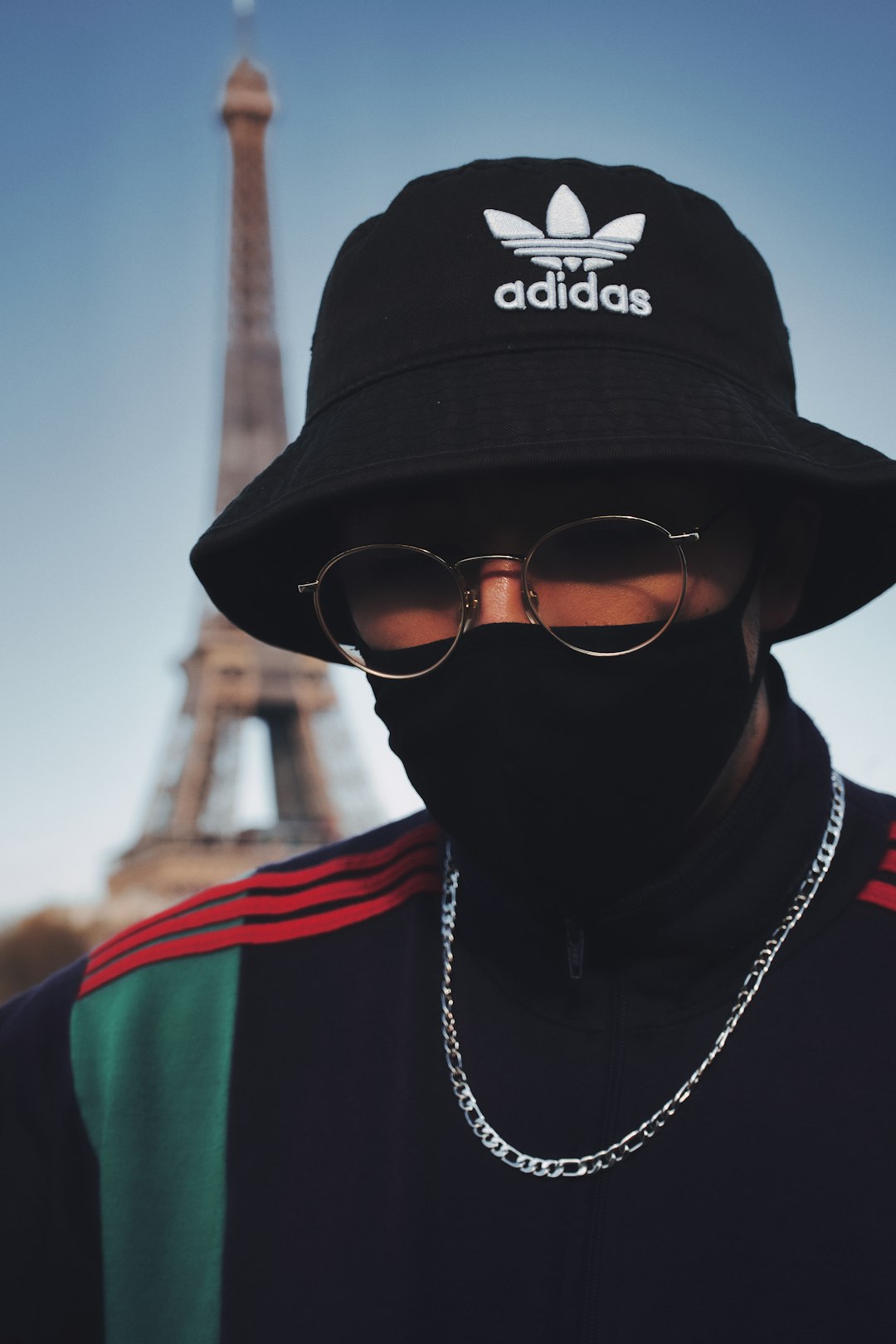 man in black and red shirt wearing black fitted cap and black sunglasses