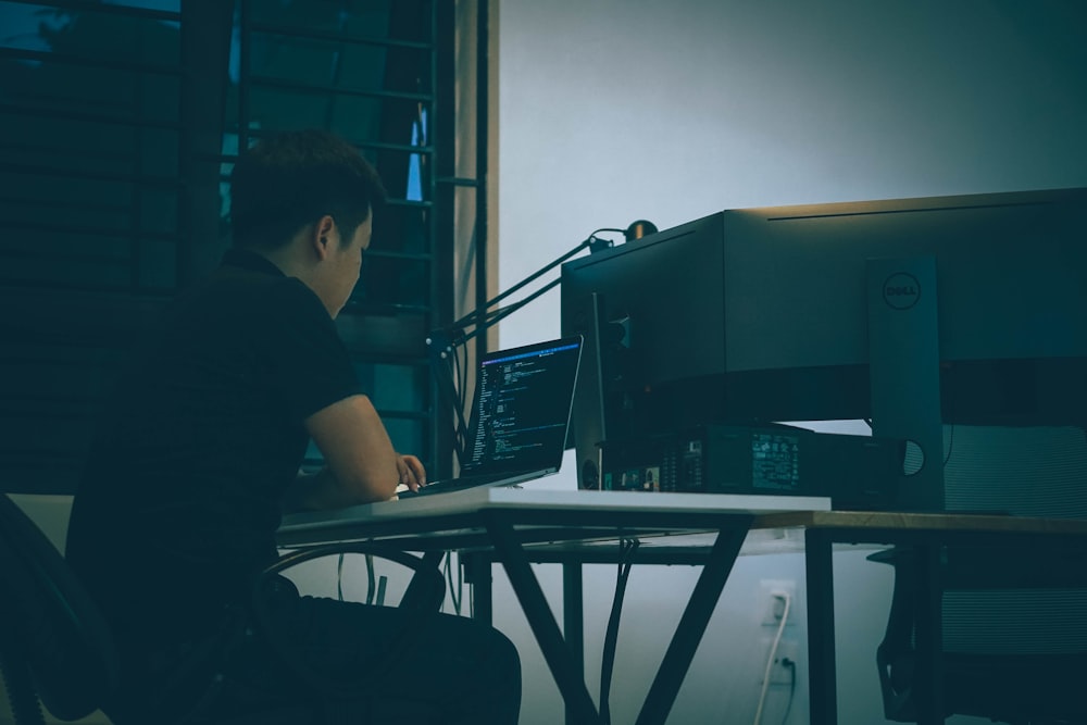 man in black t-shirt sitting on chair