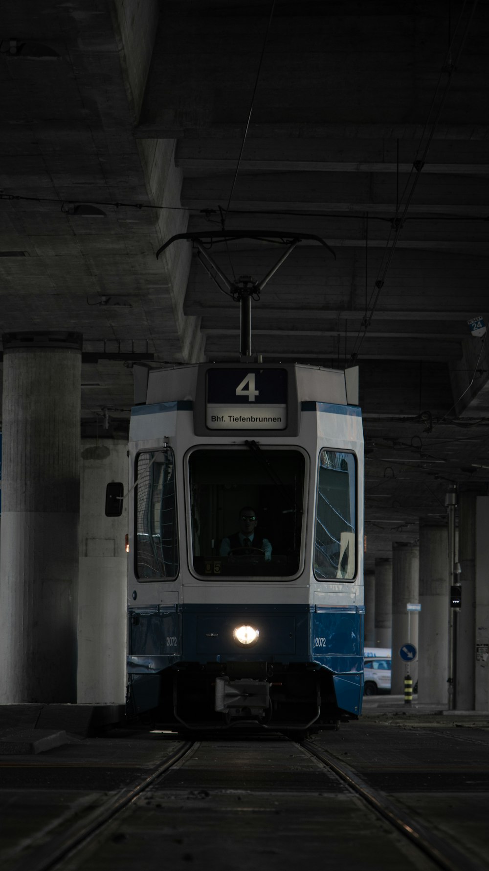 white and blue train in train station