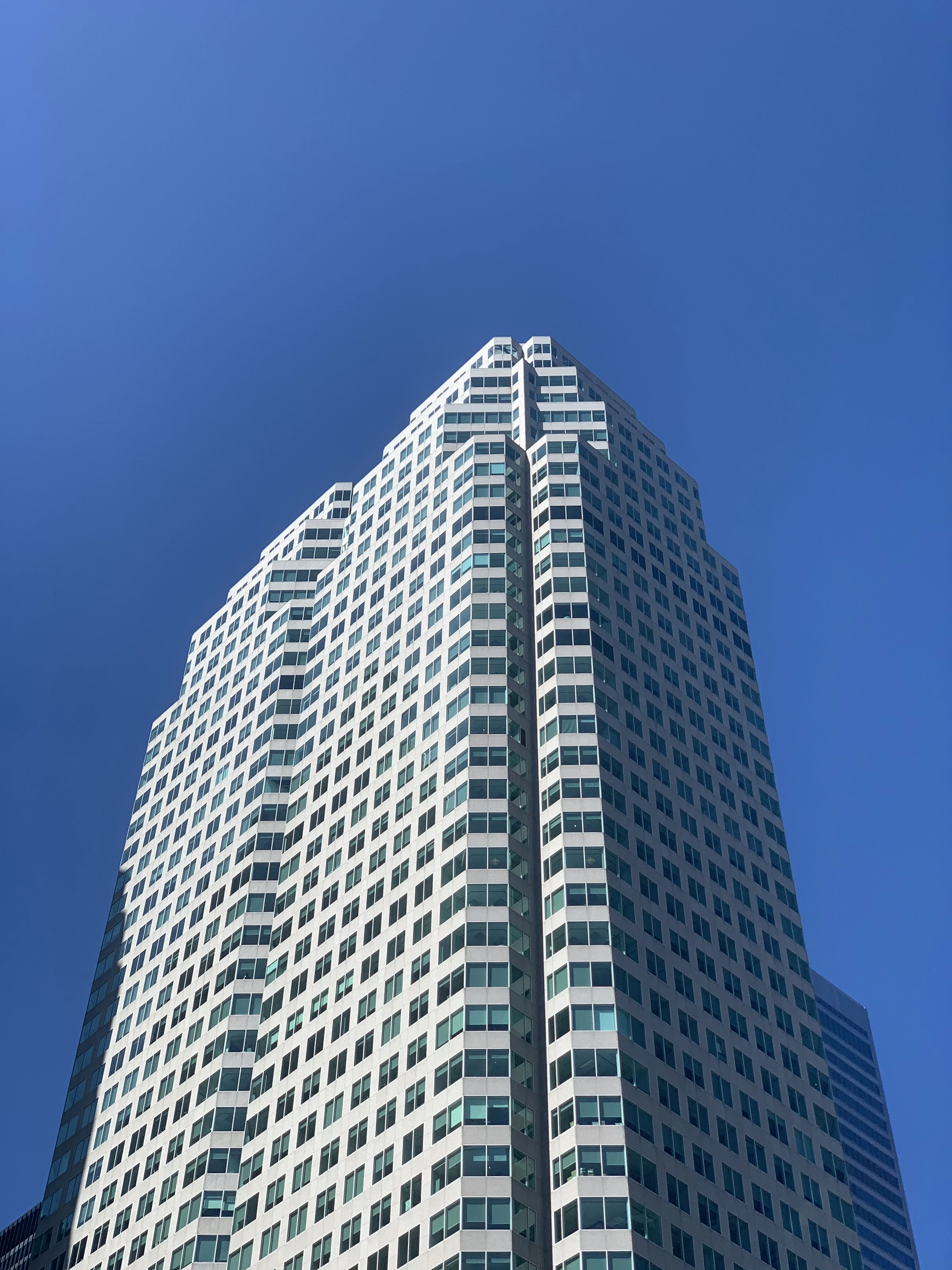 Modern concrete and glass building under blue sky