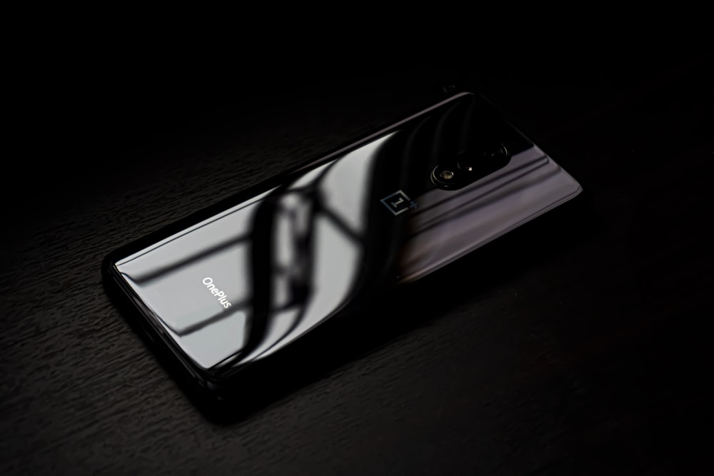 black android smartphone on brown wooden table