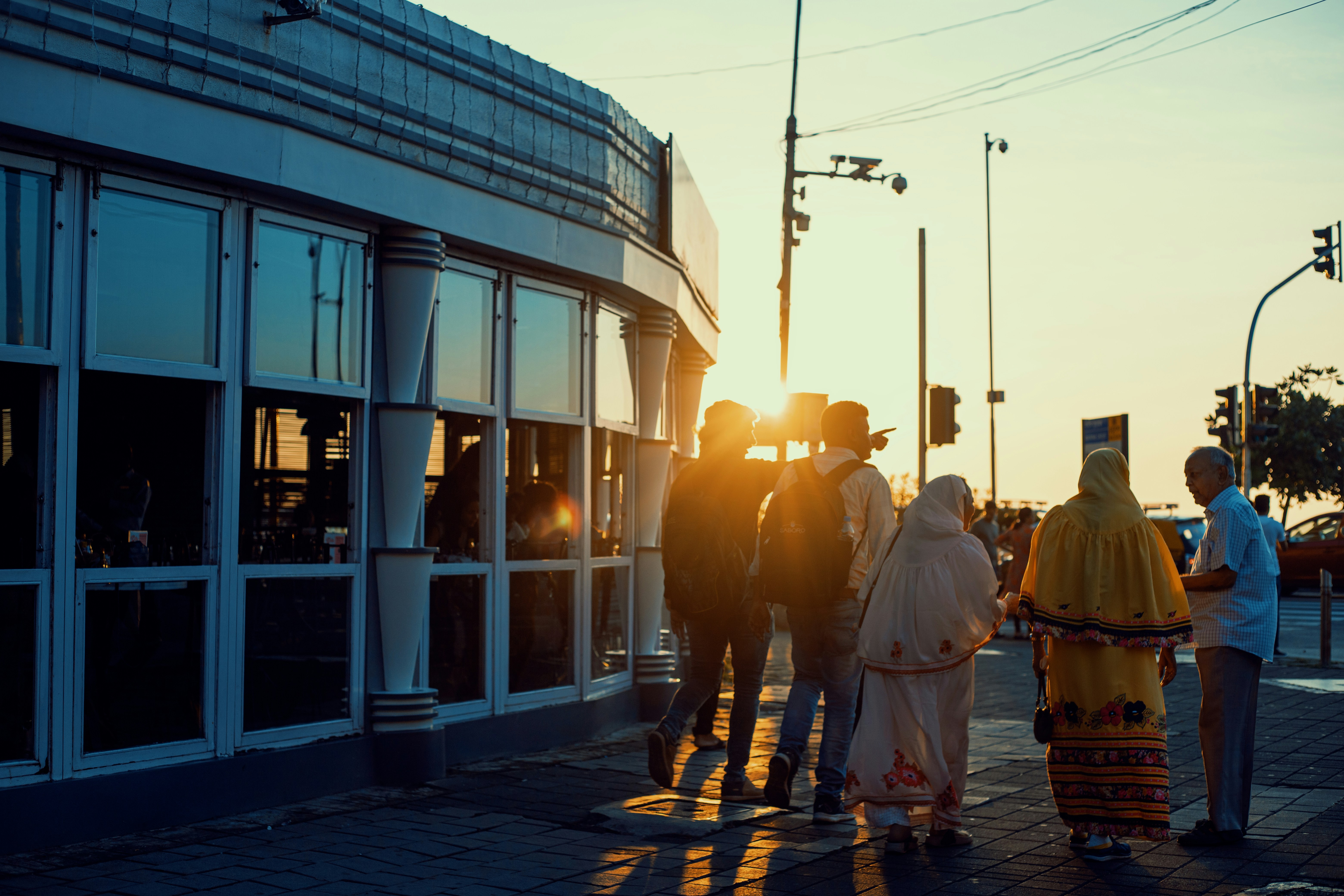 people standing in front of blue and white building during daytime