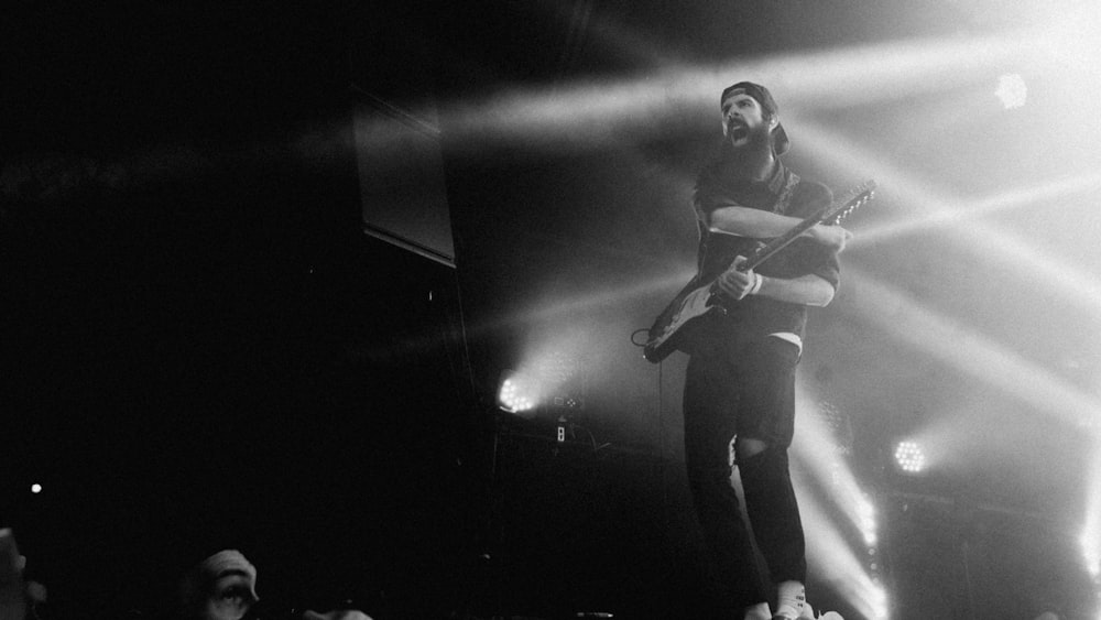 woman playing guitar on stage