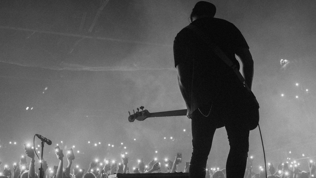 man playing guitar on concert