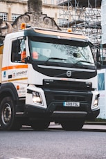 white and orange truck on road during daytime