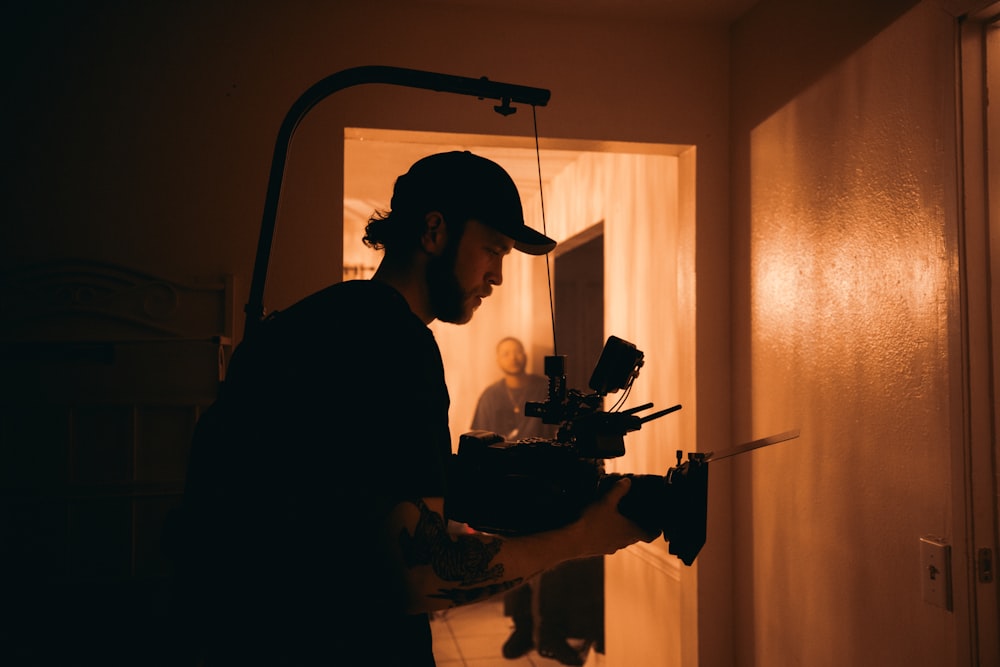 man in black shirt holding black rifle