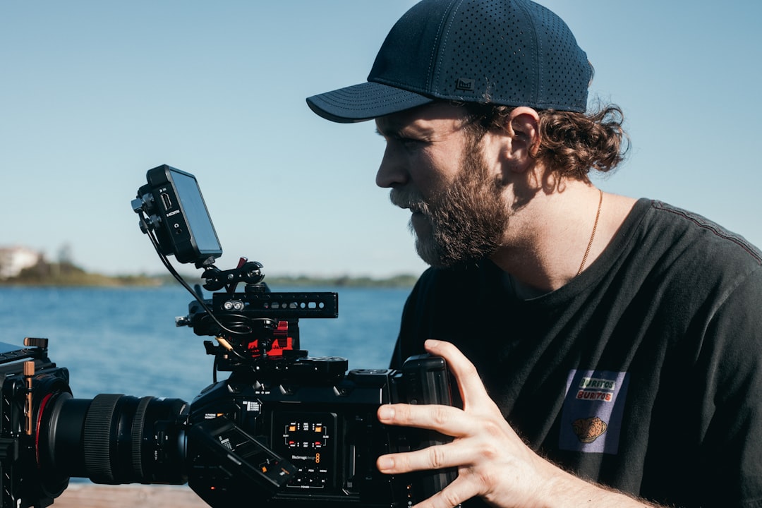 man in black crew neck t-shirt holding black dslr camera