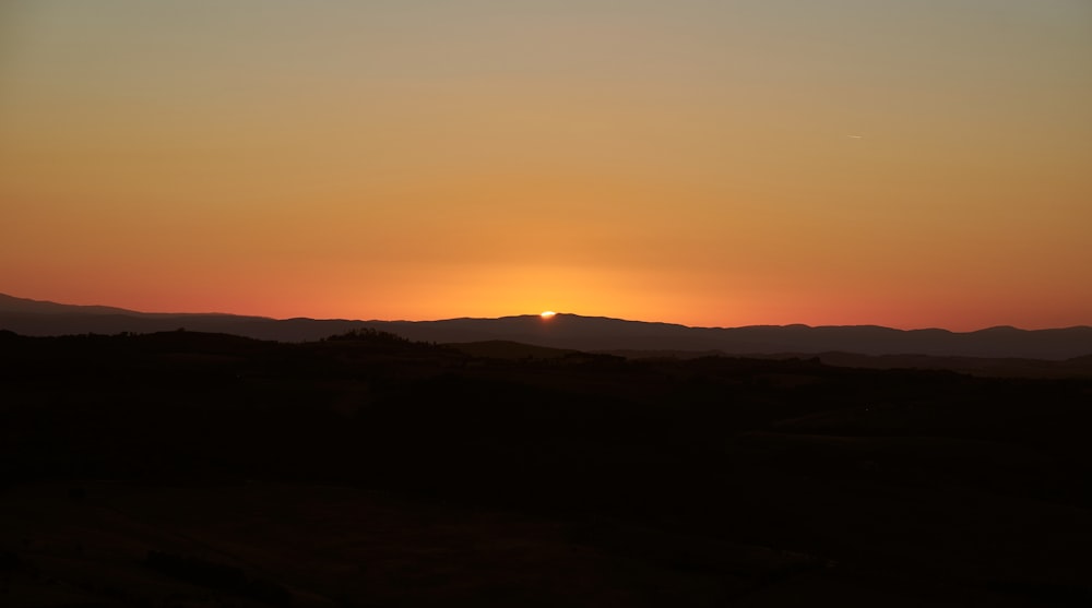 silhouette of mountain during sunset