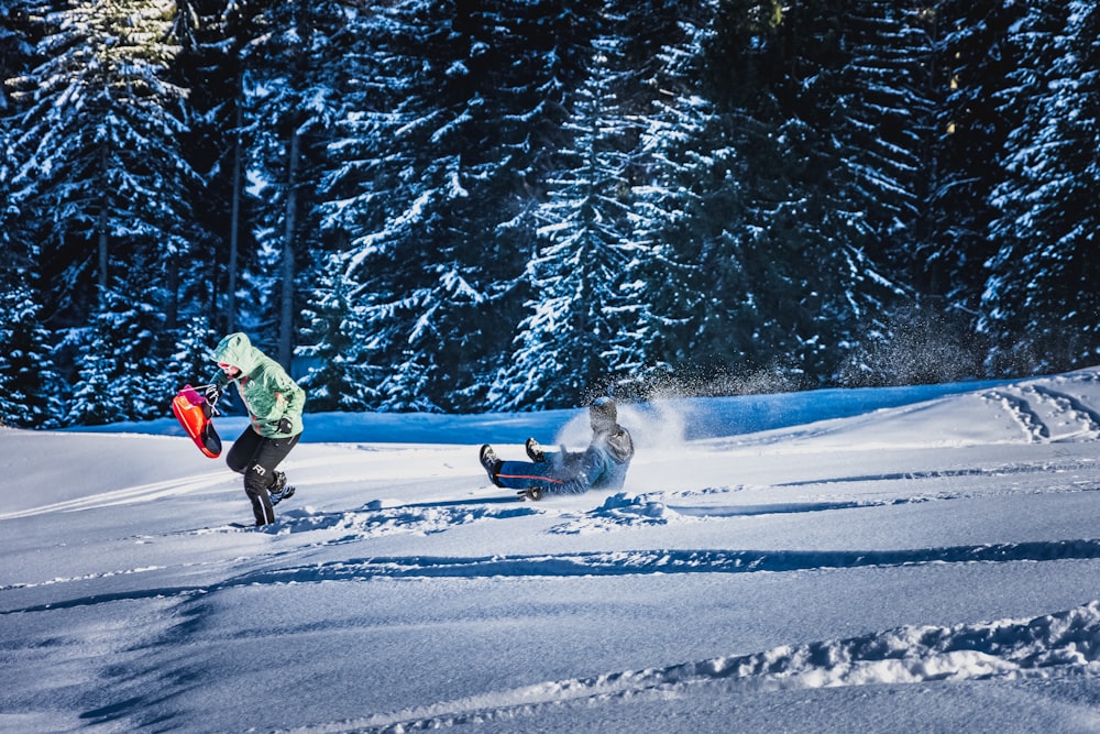 man in green jacket riding on snowboard during daytime