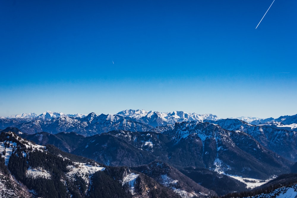 snow covered mountains under blue sky during daytime