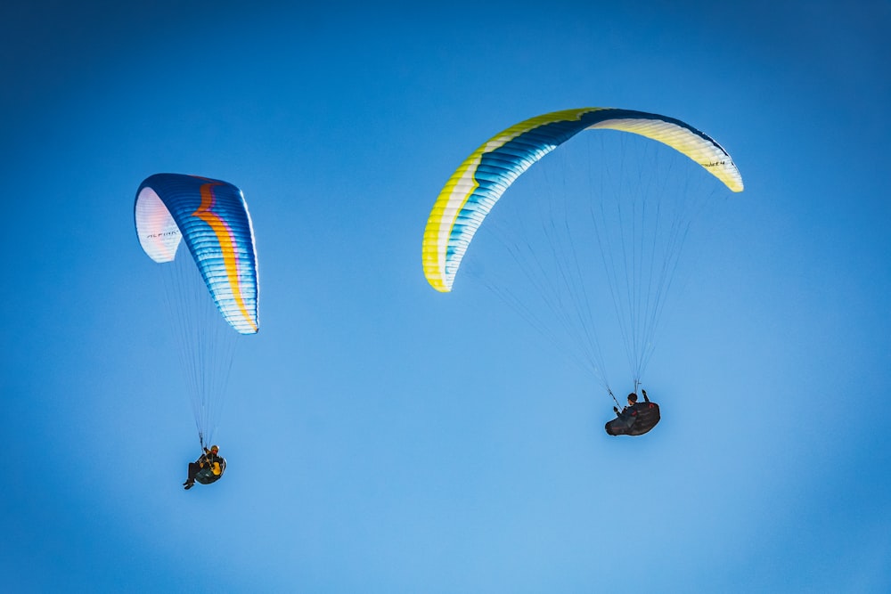 person in black shirt riding on white and red parachute