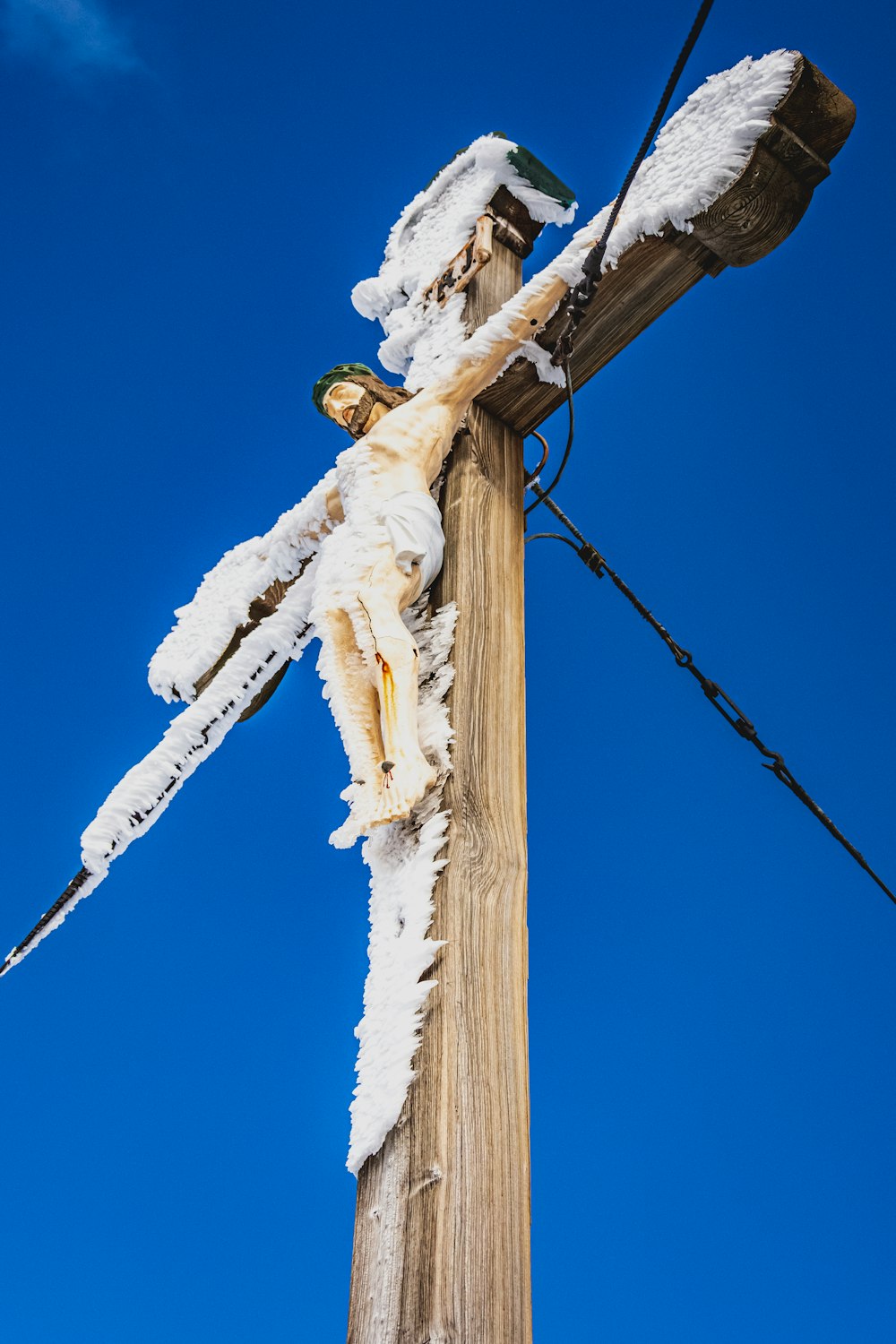 white snow on brown wooden post