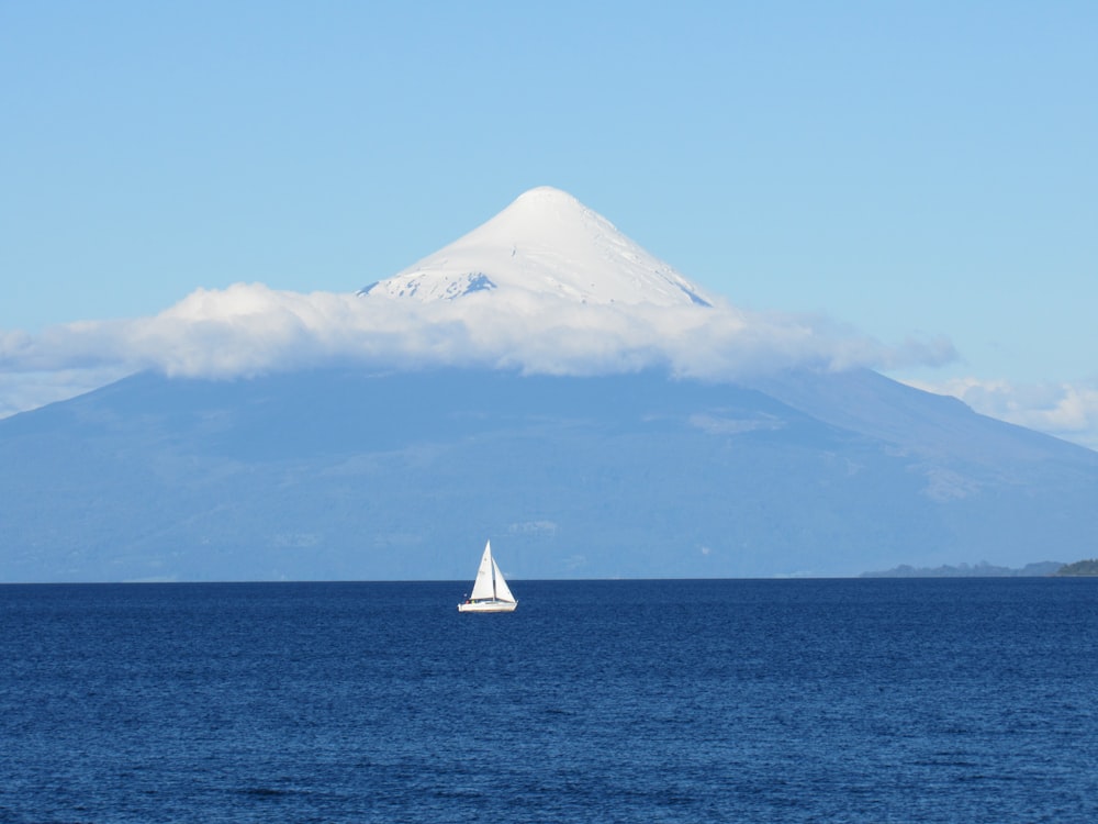 white sailboat on sea under blue sky during daytime