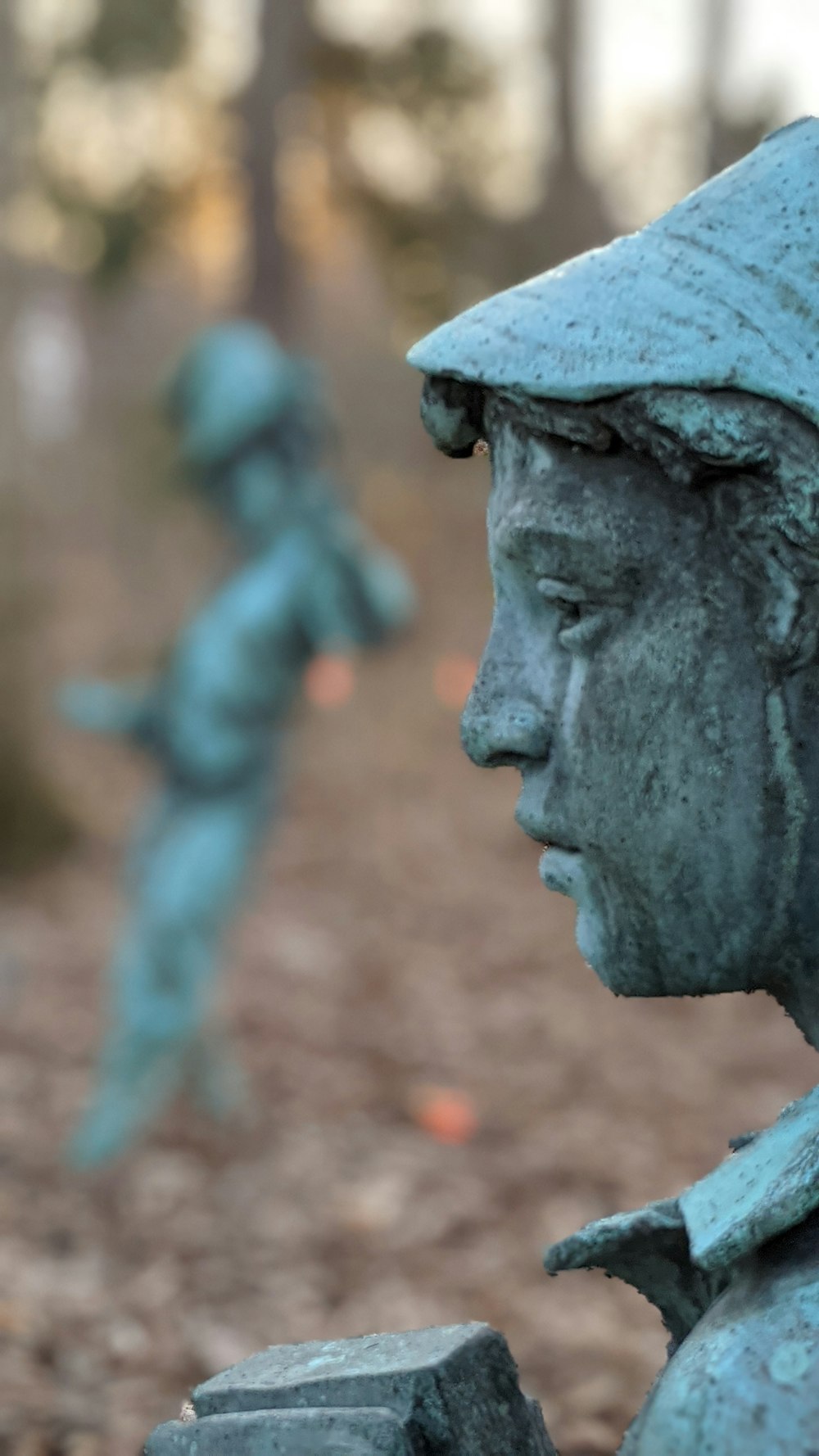 man in blue hat statue