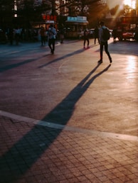 A vibrant street scene bathed in golden hour light, with candid expressions and dynamic movement.