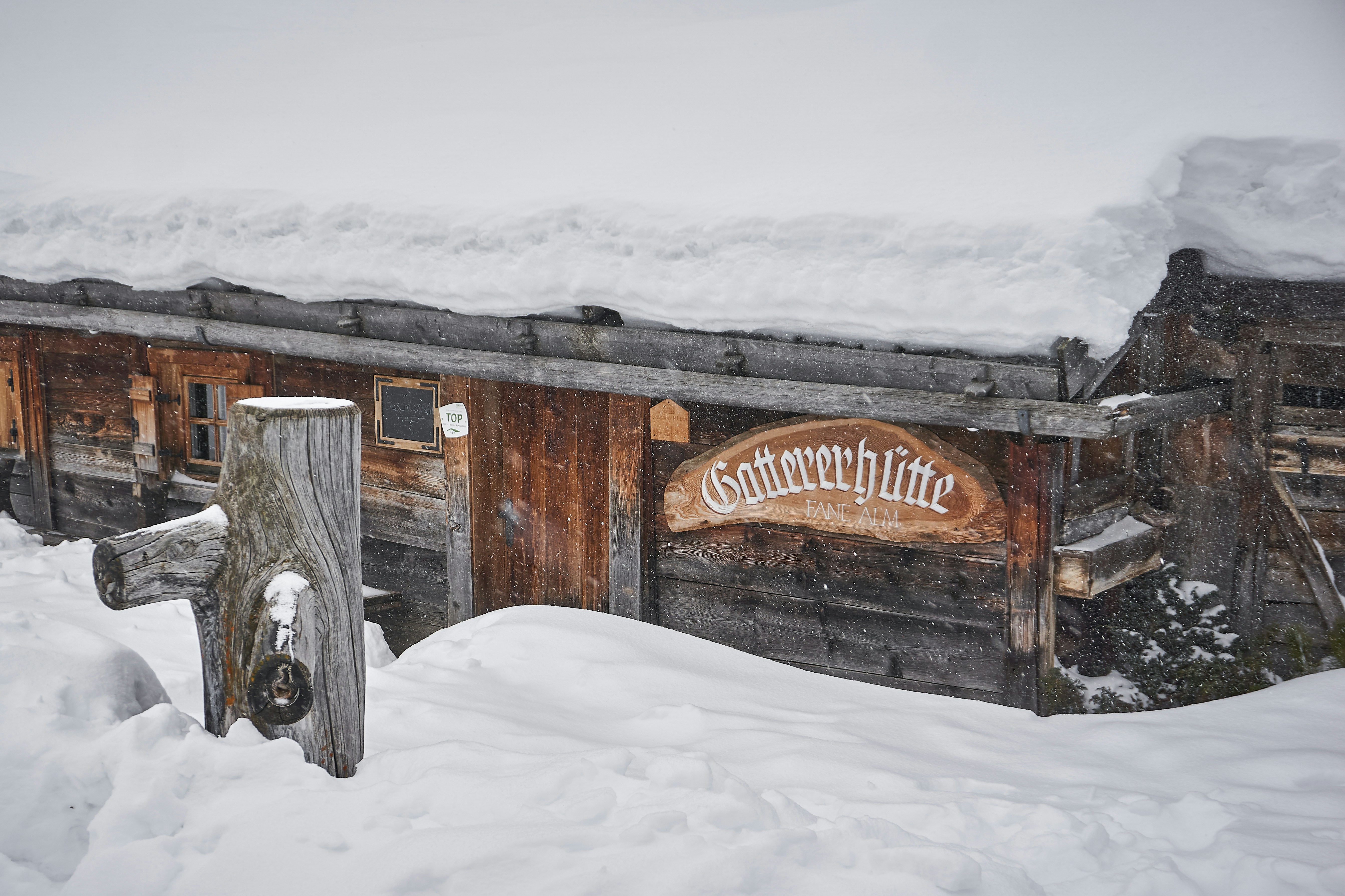 brown wooden house covered with snow