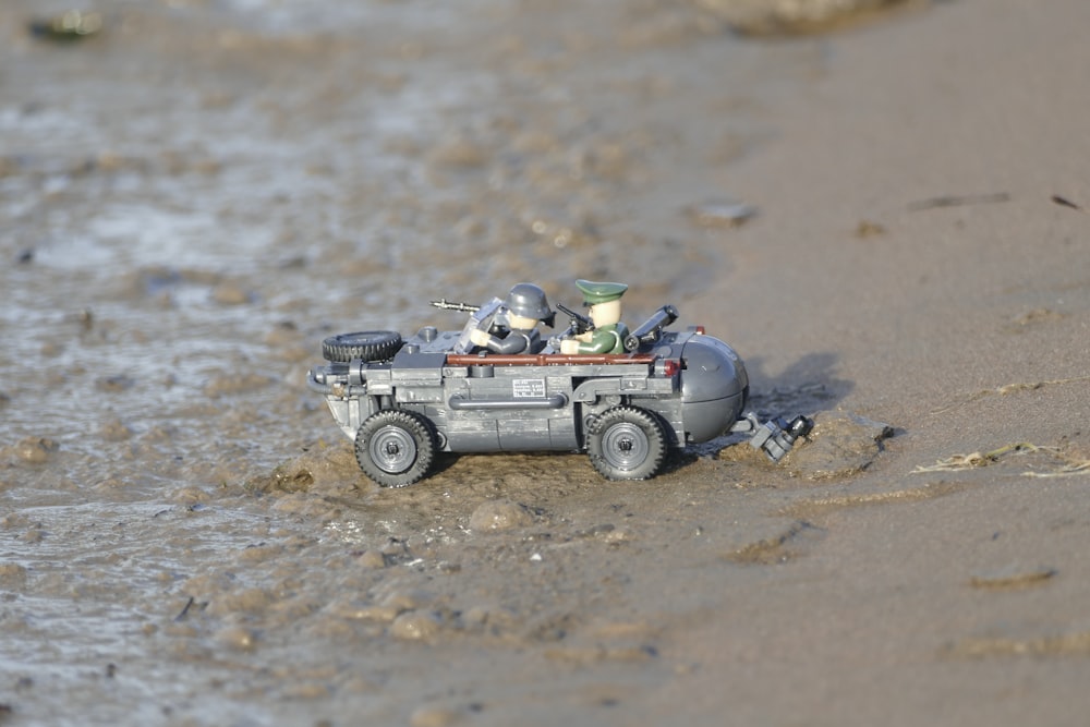 white and black car toy on beach during daytime