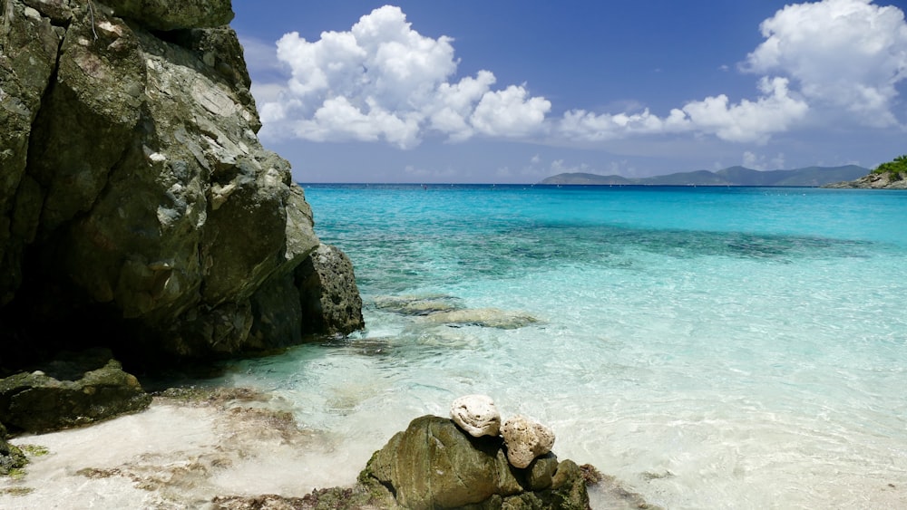 brown and gray rock formation on sea shore during daytime